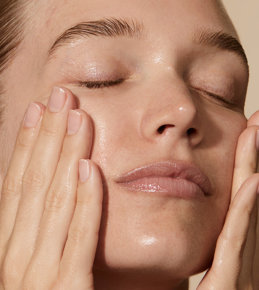 A close up of mode's face applying Silver Skin Tonic to tackle blemishes and break-out.