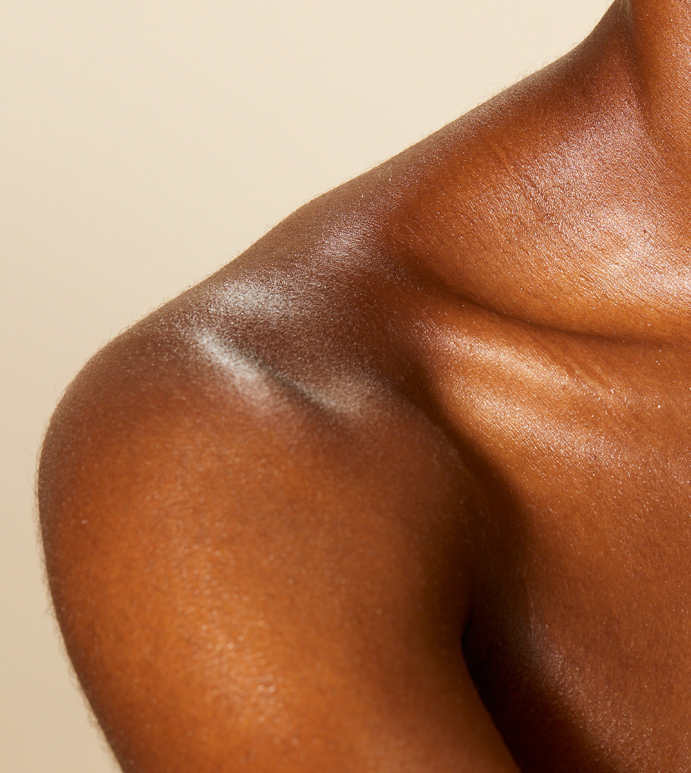 A close up of model's neck and collarbone with Firming Neck Cream applied to her skin.