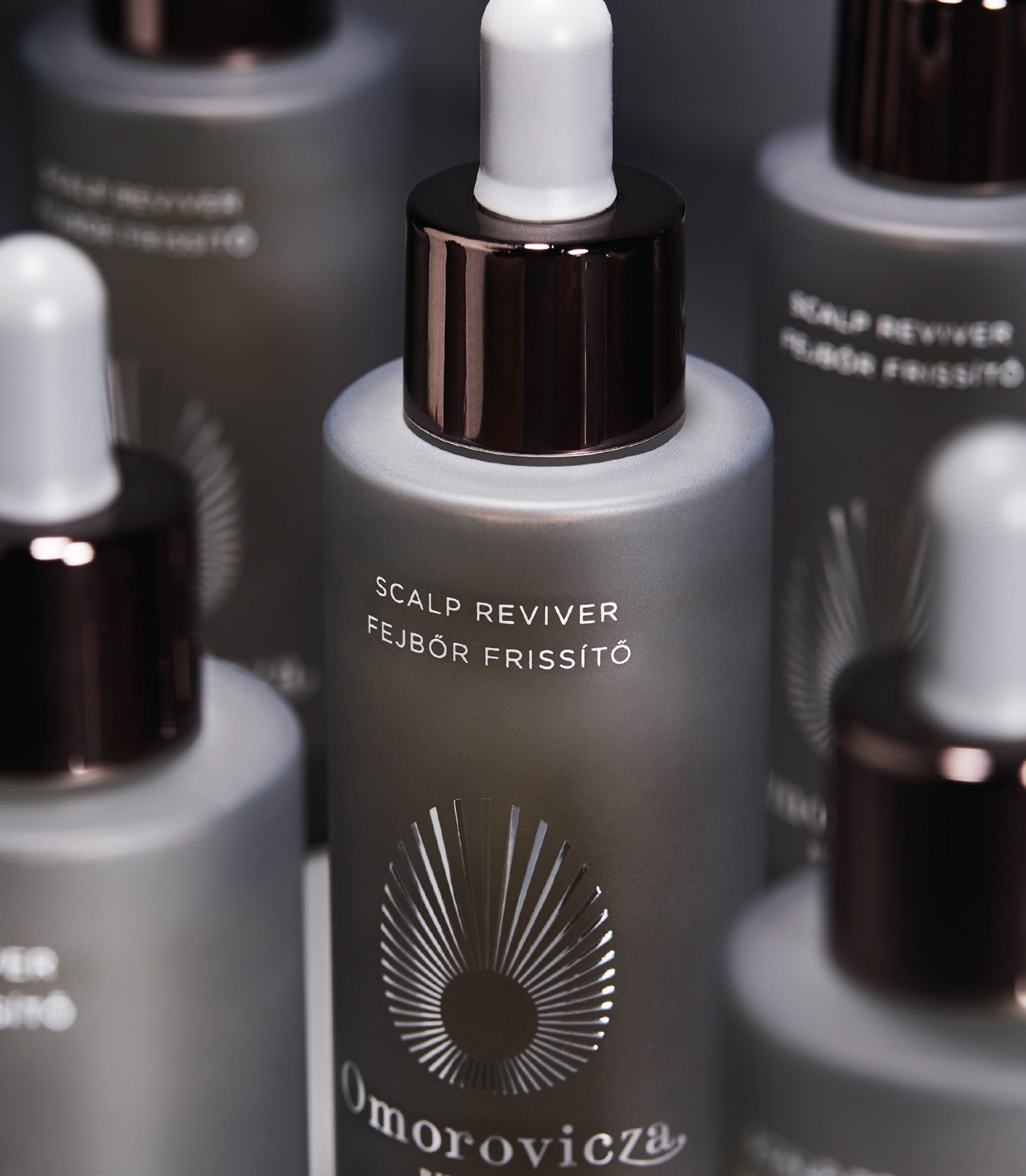 A close up shot of Scalp Reviver surrounded by other bottles of Scalp Reviver.