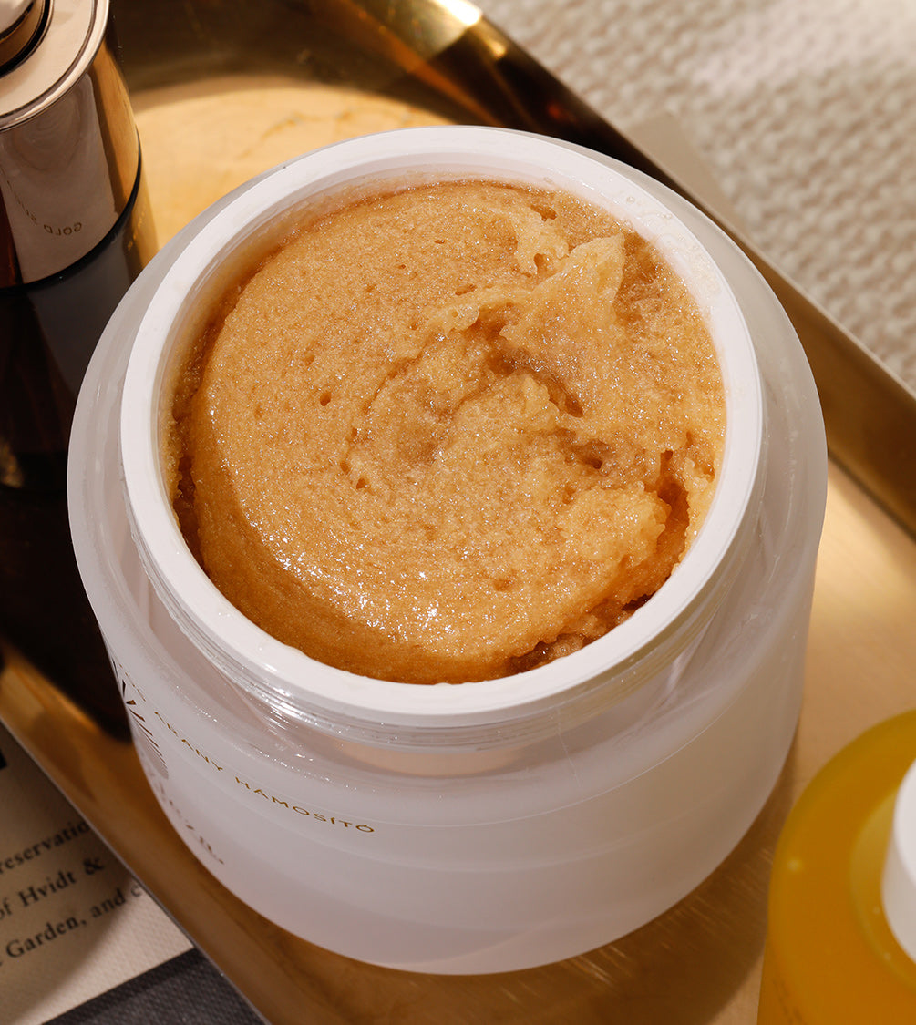 Gold Sugar Scrub in a pot, has rich and thick texture for smooth skin.