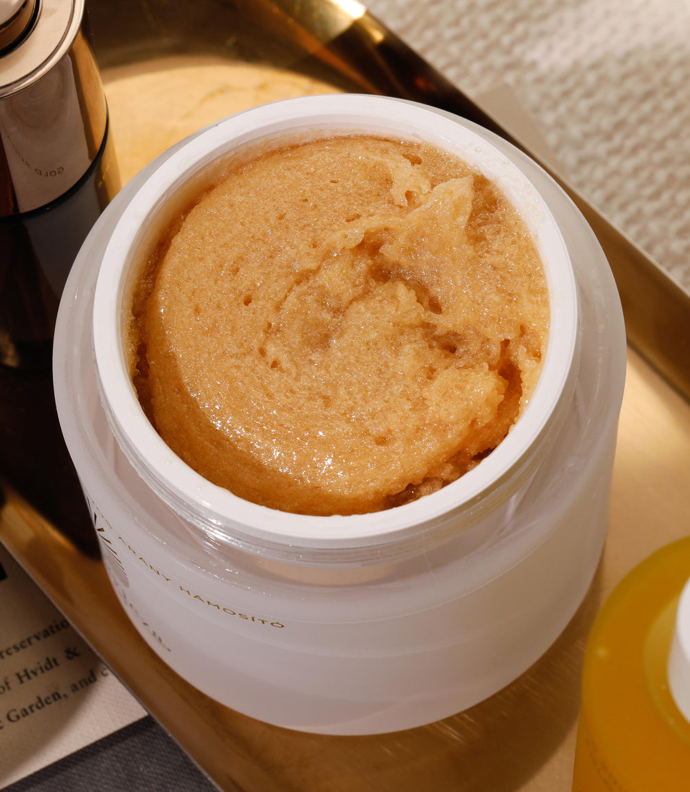 Gold Sugar Scrub in a pot, has rich and thick texture for smooth skin.