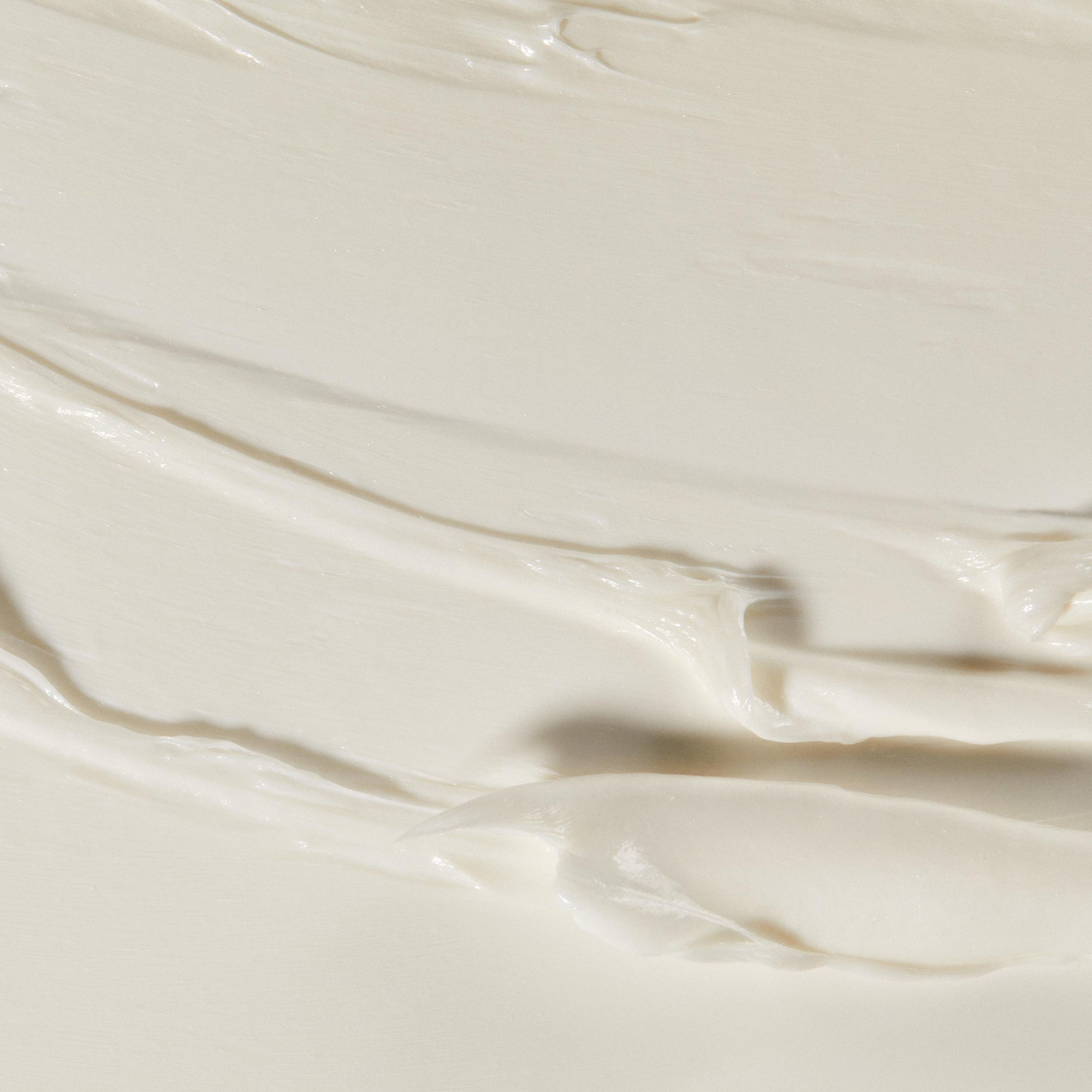 A close up of texture of Queen cleanser. Creamy and light texture in white colour.