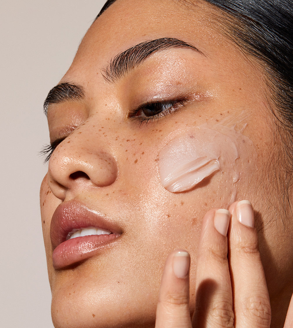 A close up of model's face with Queen Cream applied to her face. The skin looks glowy and hydrated. Nutrient-rich moisturiser combines oils to durably nourish and plump the skin