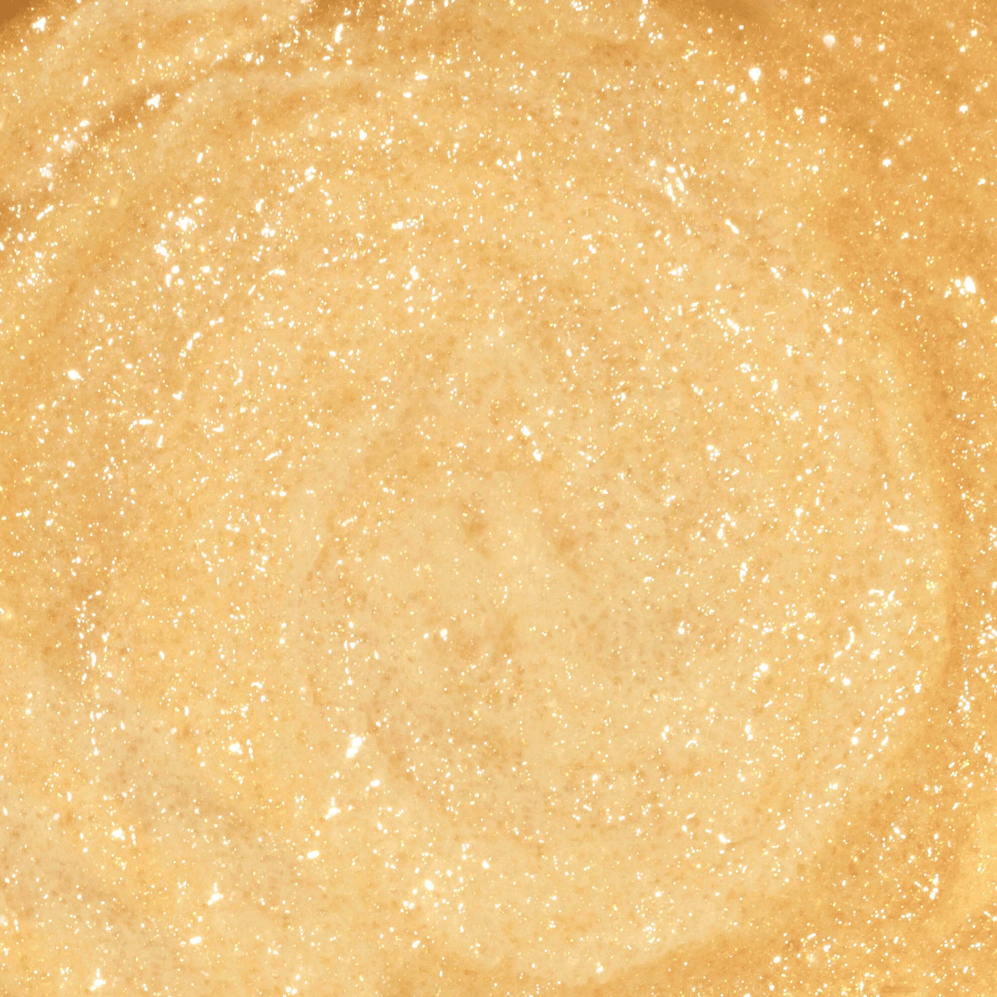 A close up of Gold sugar scrub texture with illuminating gold gold colour.